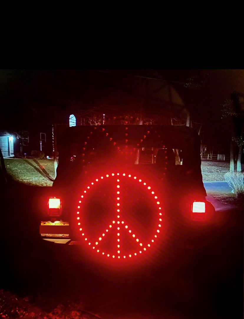Jeep Wrangler Peace Sign LED Spare Tire Cover; Red; 33 to 35-Inch Tire Cover  (66-18 Jeep CJ5, CJ7, Wrangler YJ, TJ  JK)